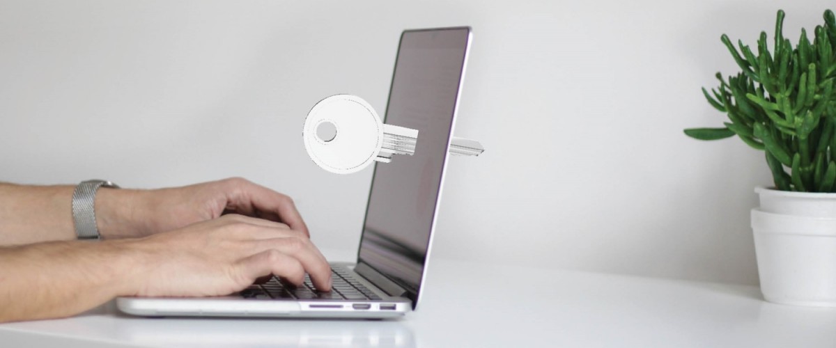 Open laptop with a key through its screen
